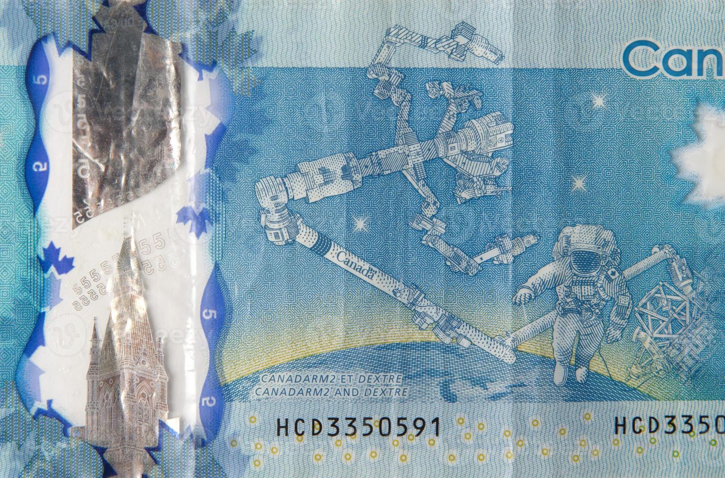 Dextre and canadarm2 on Canada 5 Dollars 2013 Polymer Banknote fragment photo