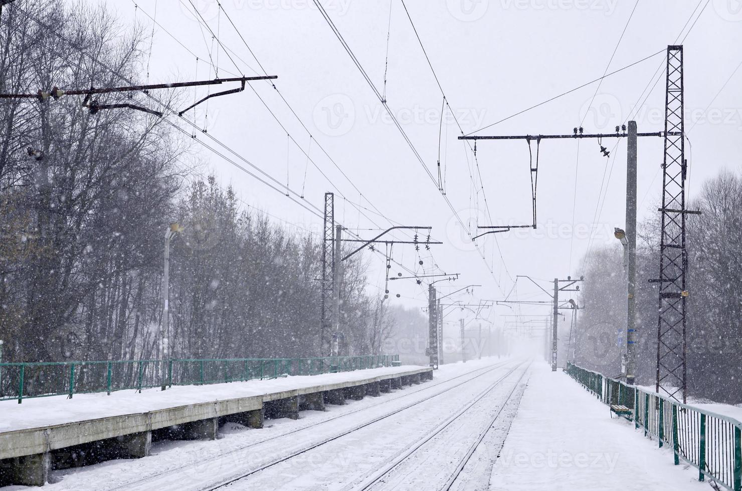 Railway station in the winter snowstorm photo