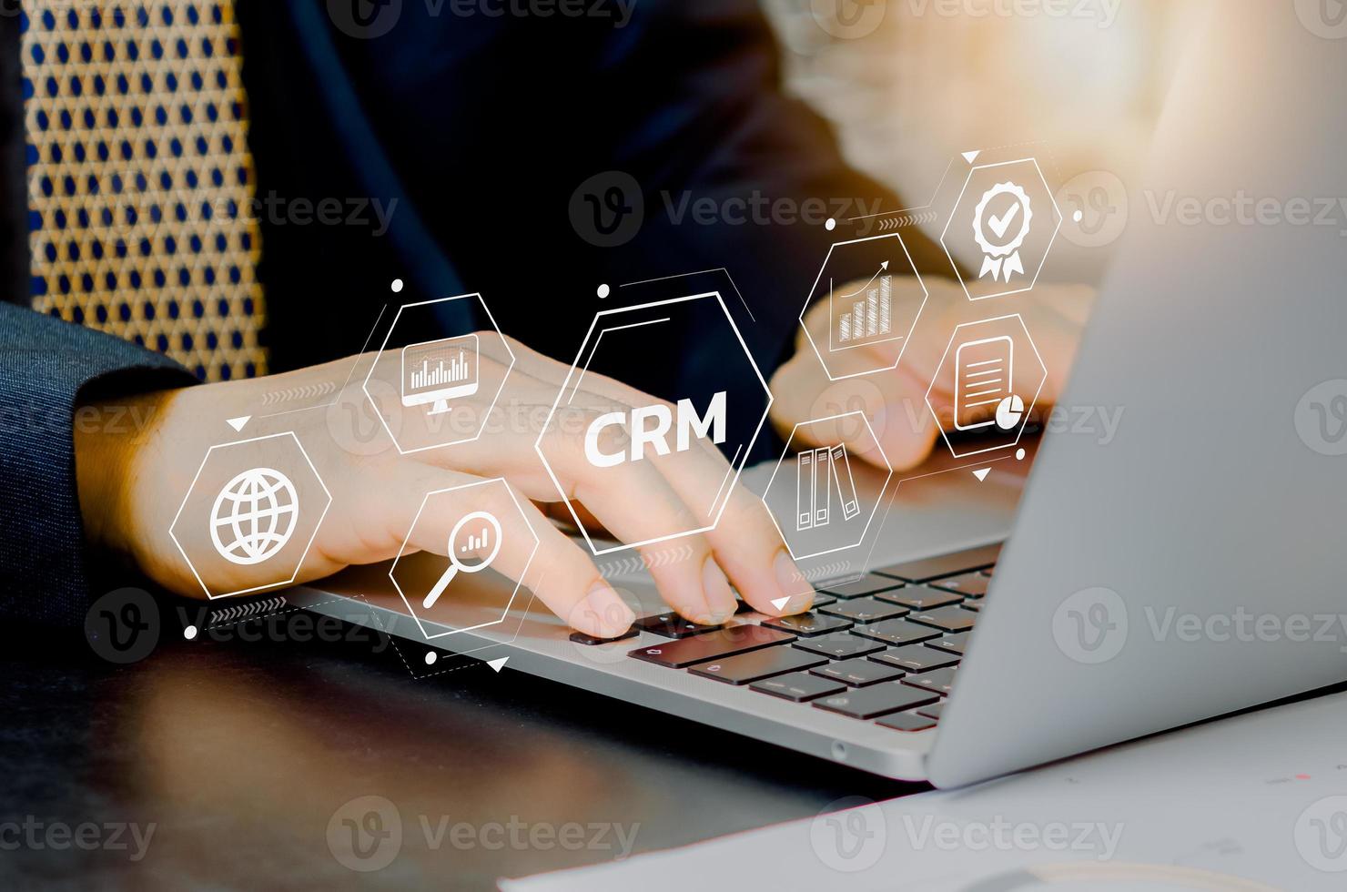 Hand typing on laptop concept. Icons CRM Customer Relationship Management business on virtual screen. photo