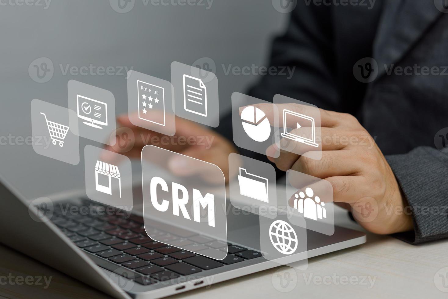 Hand typing on laptop concept. Icons CRM Customer Relationship Management business on virtual screen. photo