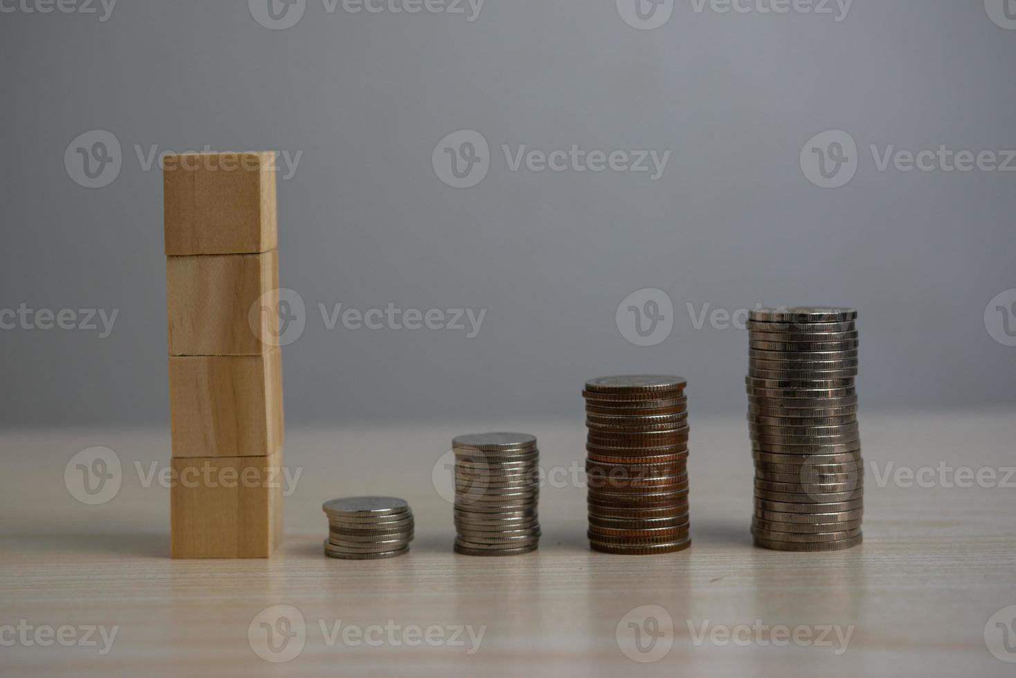Stack coin and wood block cube blank on desk. photo