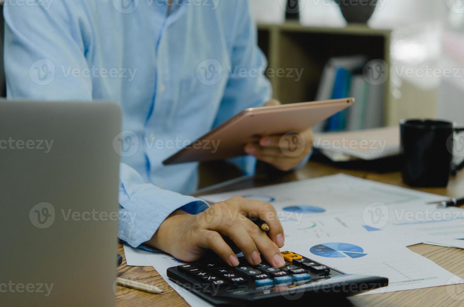 Businessman working at office with document on his desk.Paperwork graph report planning analyzing the financial and investment analysis concept. photo