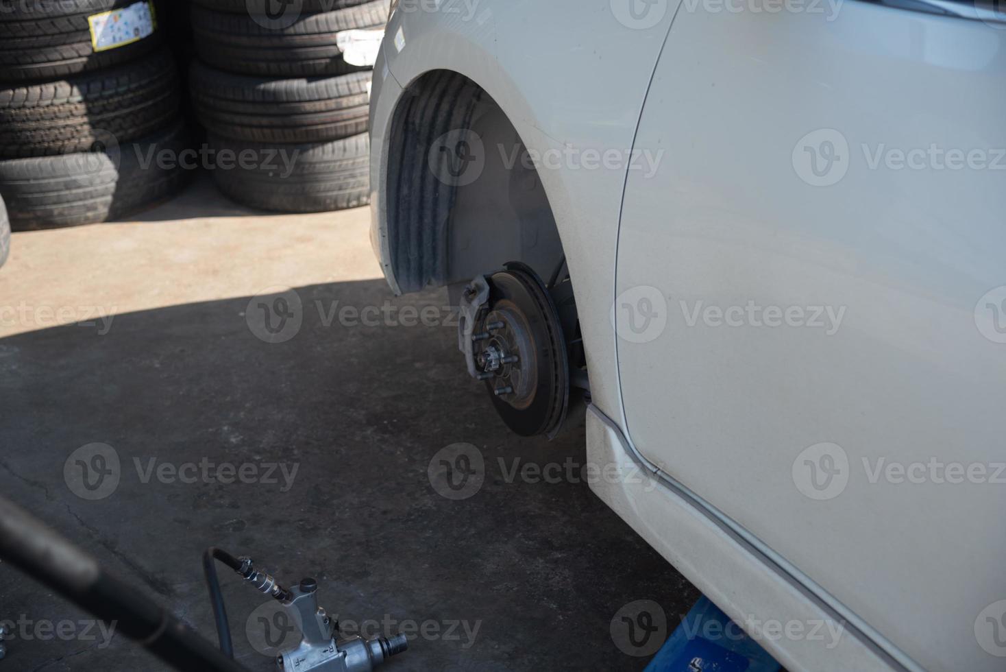 Change a car tire caused by a flat tire by using a jack to lift the car. photo