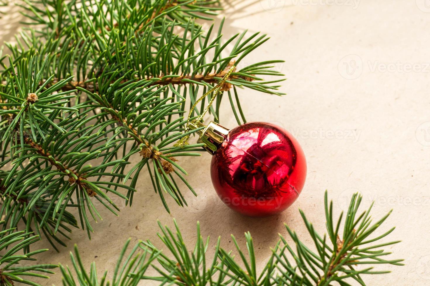 Fir tree branches decorated with red christmas balls as border on a rustic holiday background frame with copy space photo