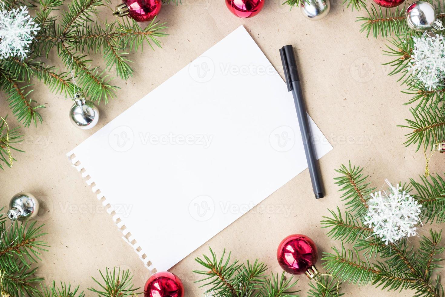 Festive christmas border with red and silver balls on fir branches and snowflakes on rustic beige background photo