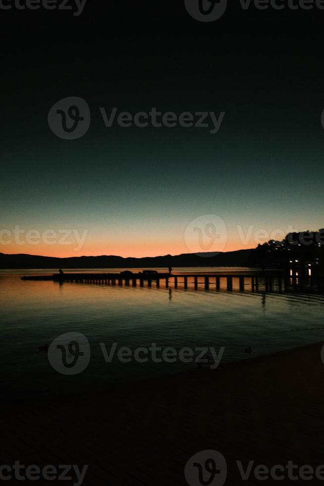 Ohrid lake sunset behind the mountains photo