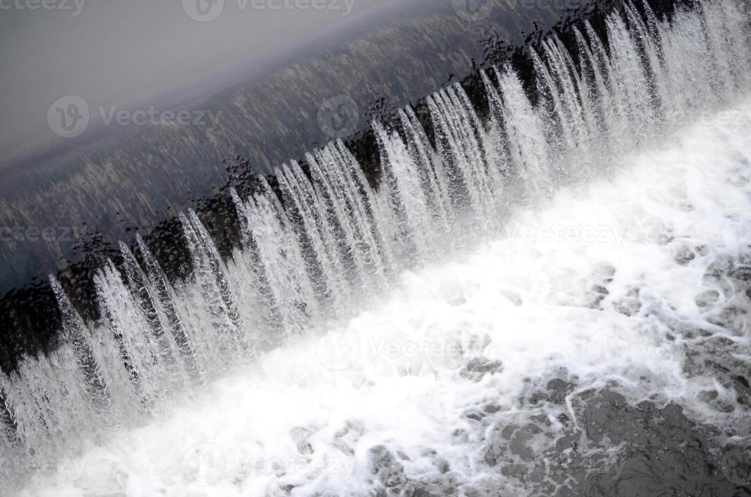 A picture of the flowing water. The dam is designed to regulate the water level in rivers within the city and to provide technical water to industrial objects photo