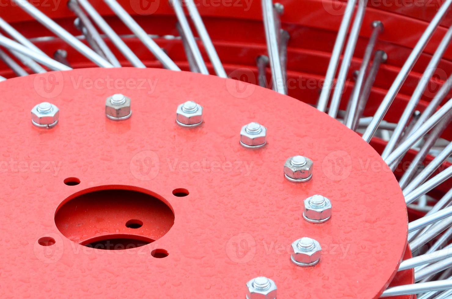 New red tedder for trailer in agricultural machinery for gathering hay. Close up photo