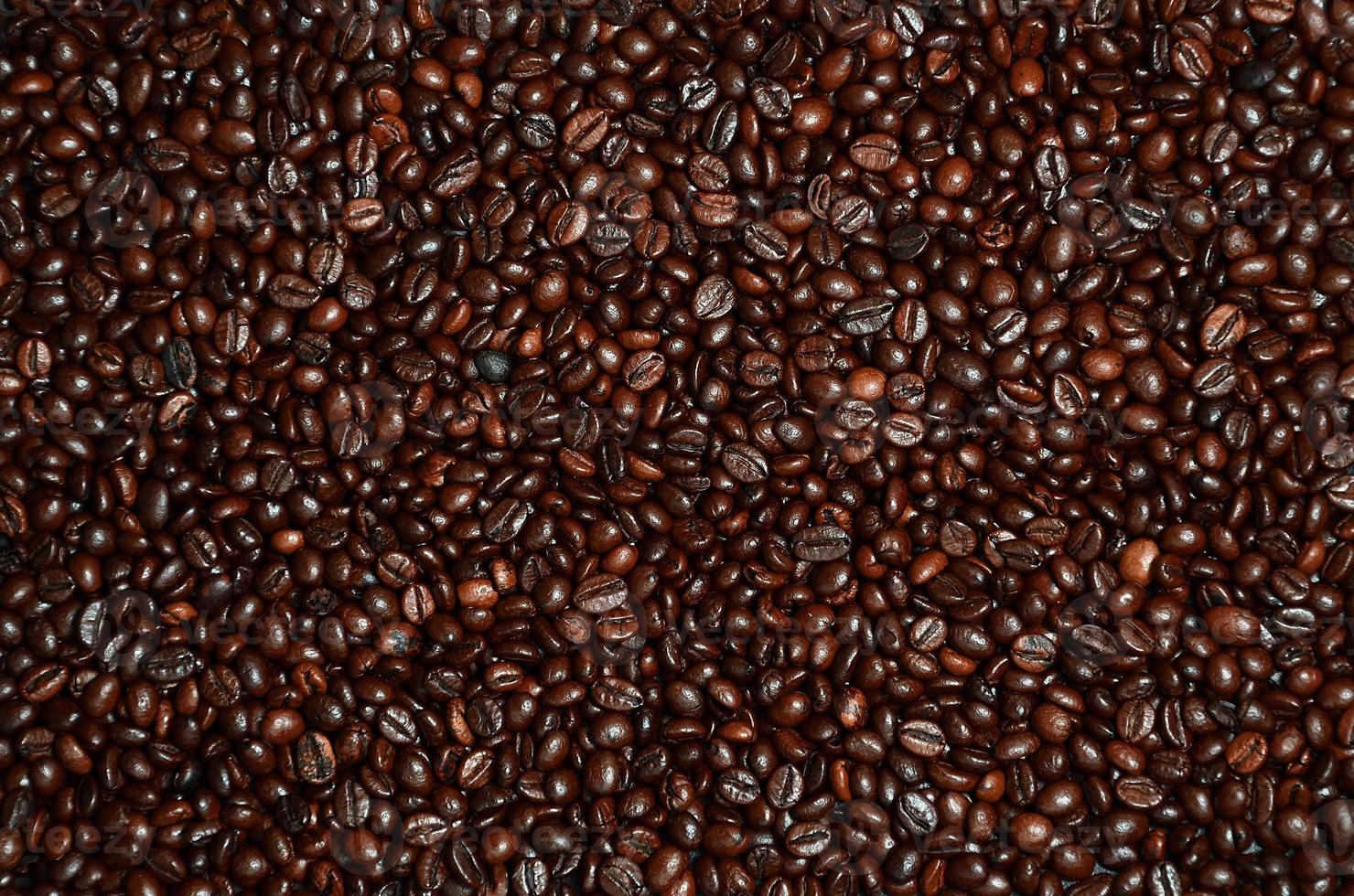 Background texture of a huge number of fragrant and fresh brown roasted coffee grains photo