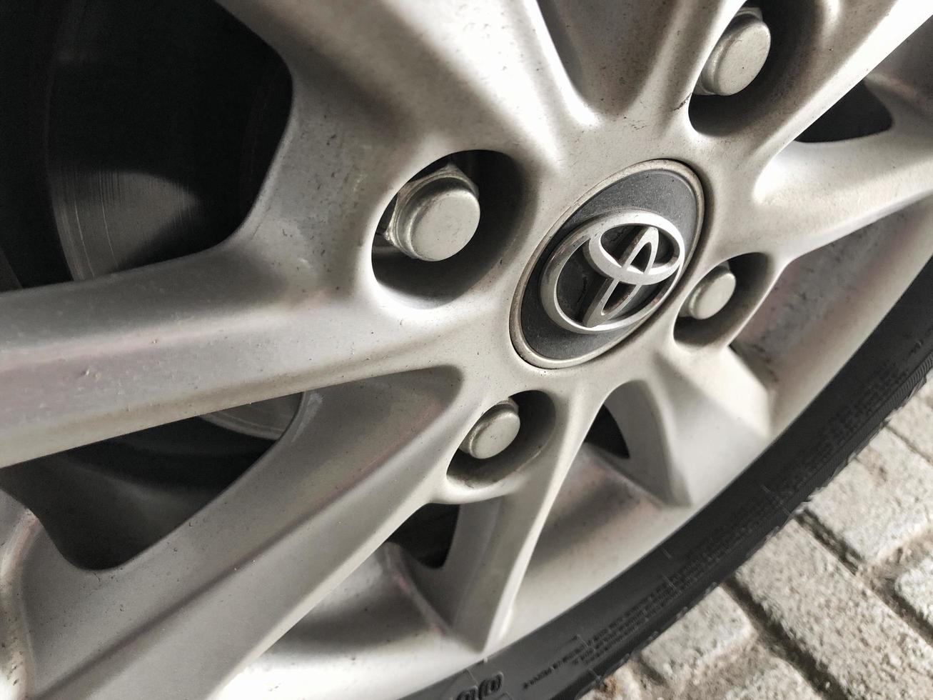 BLITAR, INDONESIA - October 20th 2022 Close-up of all-new Toyota Avanza rim tires, car showroom. Modern transportation. photo