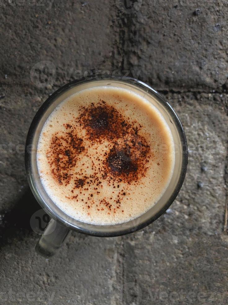 High angle view of a cup cappuccino coffe on paving photo