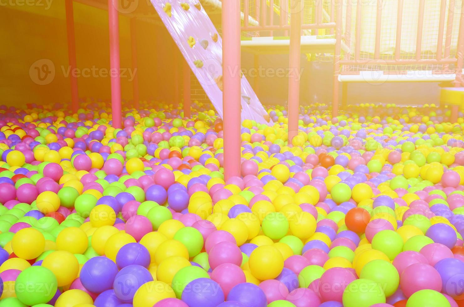 Many colorful plastic balls in a kids' ballpit at a playground photo