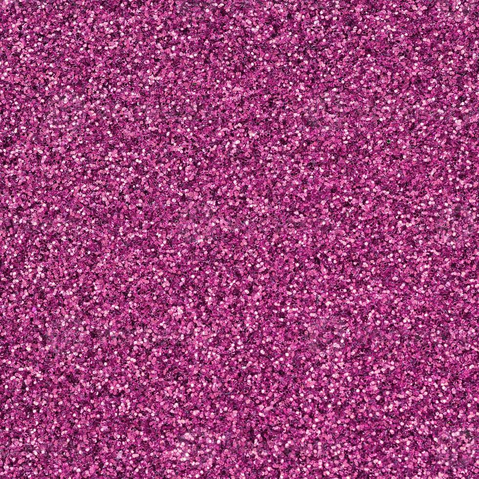 Pink decorative sequins. Background image with shiny bokeh lights from small elements photo
