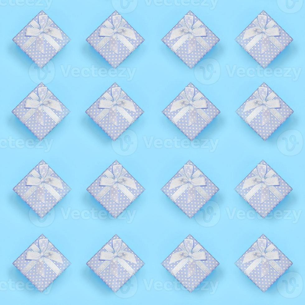 A lot of blue gift boxes lies on texture background of fashion pastel
