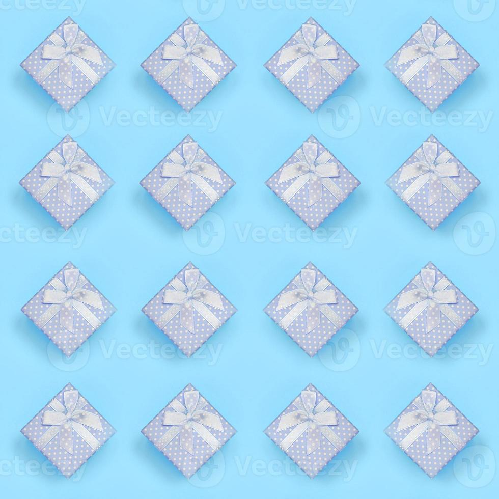 A lot of blue gift boxes lies on texture background of fashion pastel blue color paper in minimal concept photo