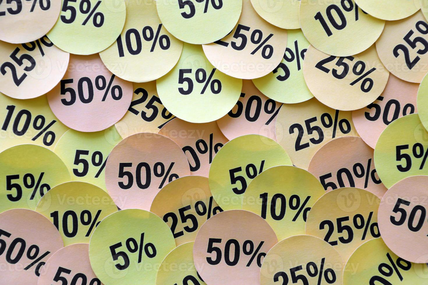 Large amount of stickers with yellow percentage values for black friday or cyber monday sale. Abstract image of discount prices photo
