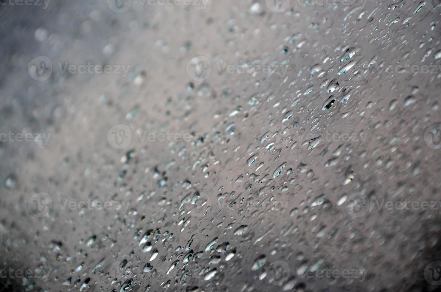 Background image of rain drops on a glass window. Macro photo with shallow depth of field