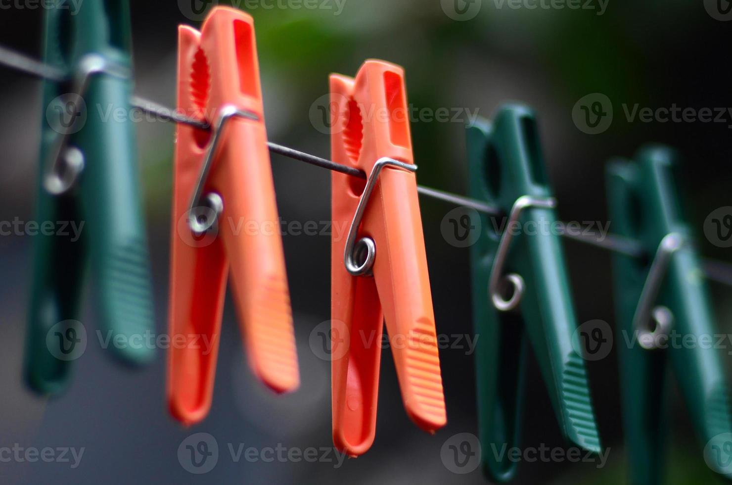 Clothespins on a rope hanging outside house and apple tree photo