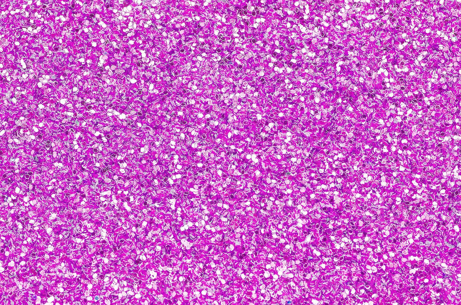 Pink decorative sequins. Background image with shiny bokeh lights from small elements photo