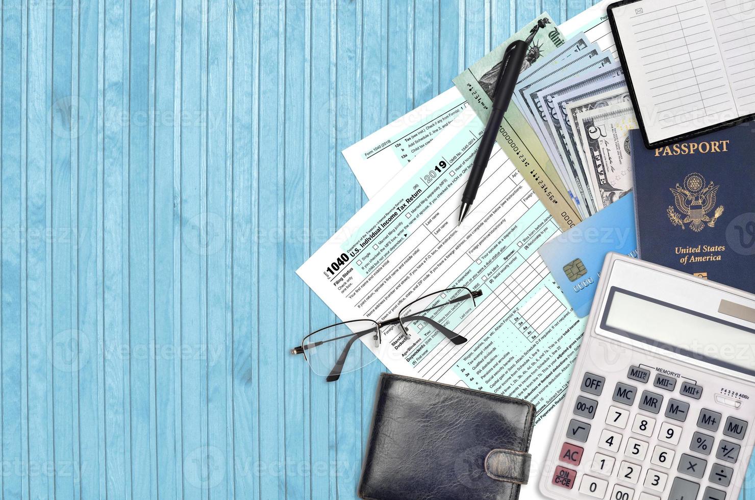 IRS form 1040 U.S. Individual income tax return with refund check lies on flat lay office table and ready to fill. U.S. Internal revenue services paperwork concept photo