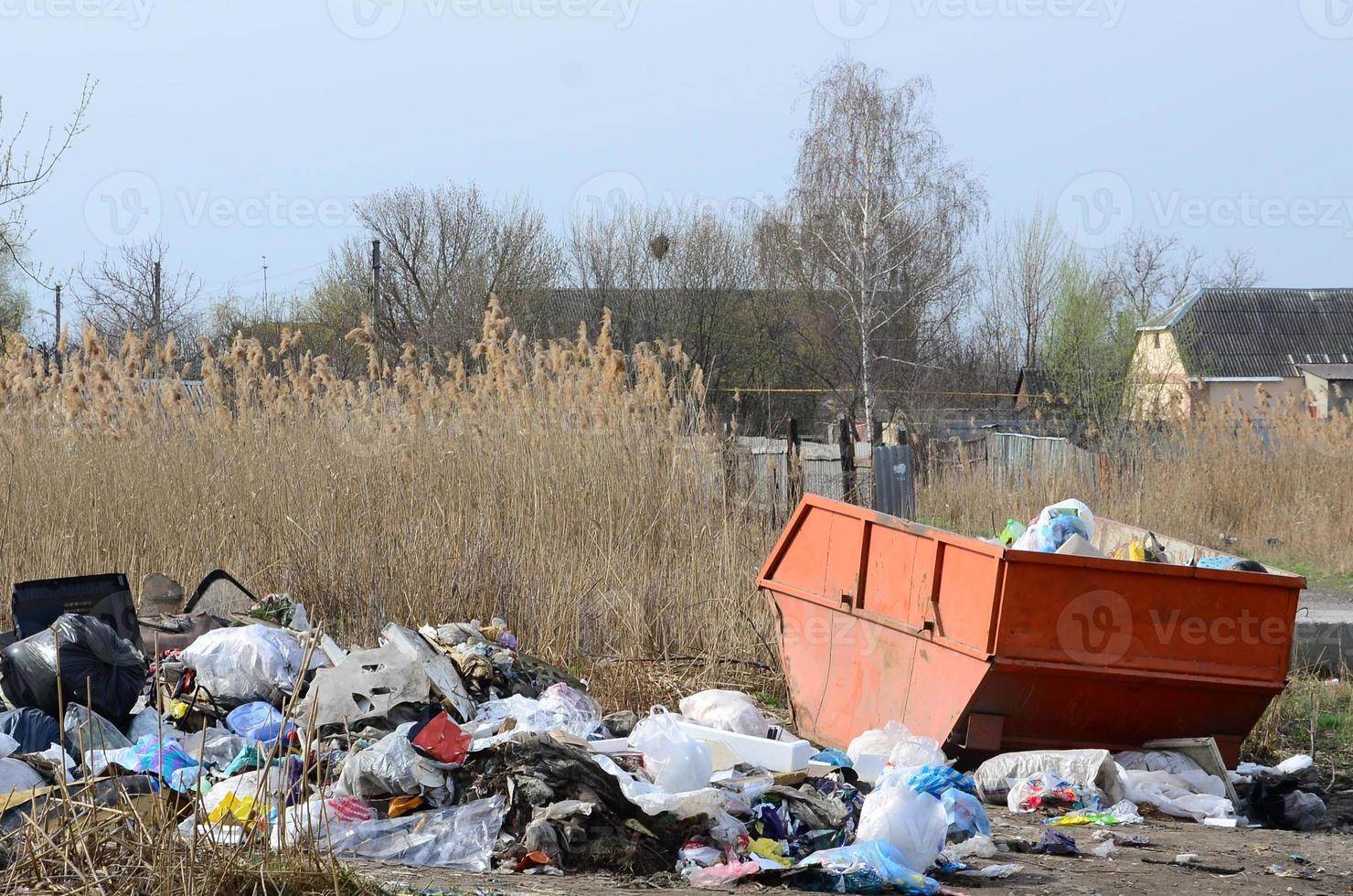 The garbage can is packed with garbage and waste. Untimely removal of garbage in populated areas photo