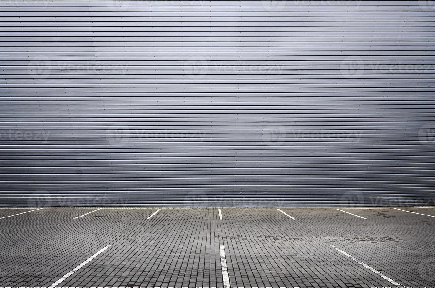Empty parking spaces on the background of a metal wall with space for product placement photo