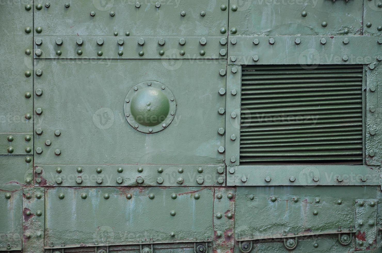 The texture of the wall of the tank, made of metal and reinforced with a multitude of bolts and rivets. Images of the covering of a combat vehicle from the Second World War photo