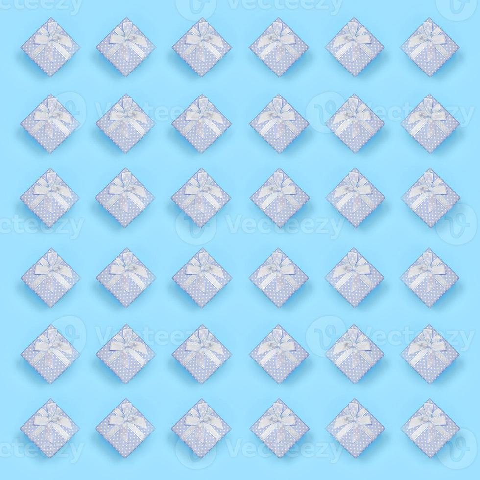 A lot of blue gift boxes lies on texture background of fashion pastel blue color paper in minimal concept photo