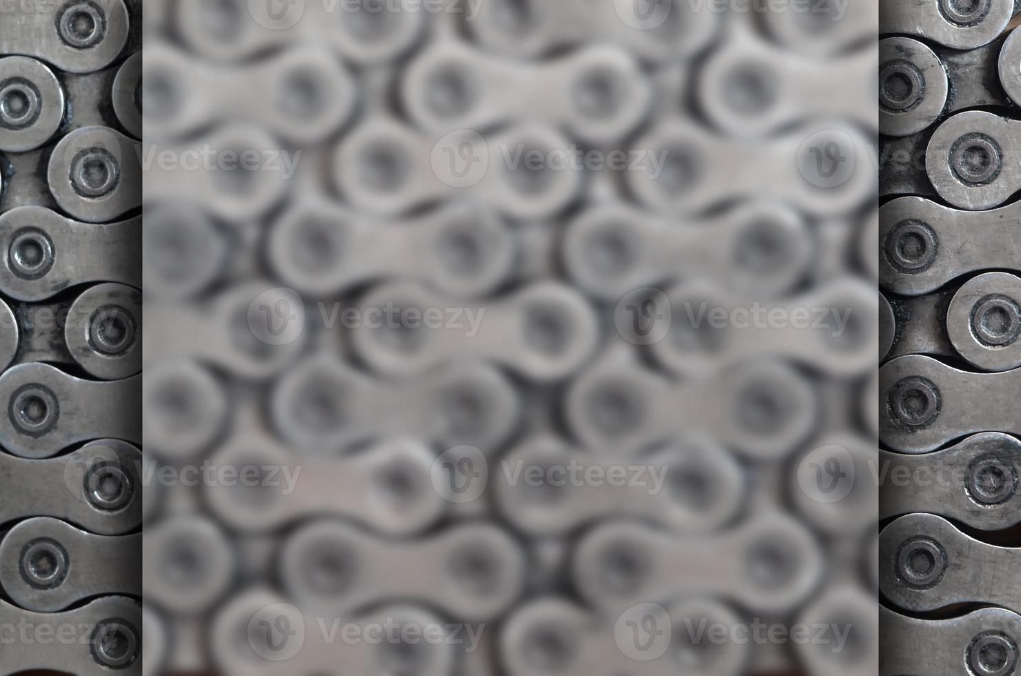 Dirty and oily chain from a mountain bike lying on a wooden table in a bicycle shop photo