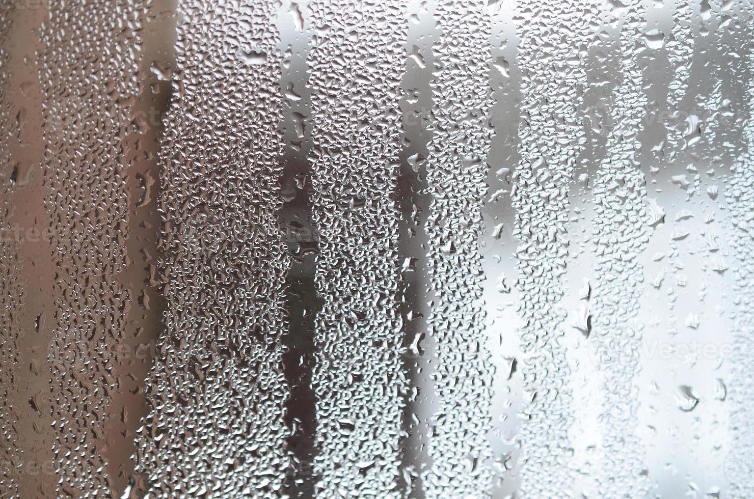 The texture of a misted glass with a lot of drops and condensation flows. Background image photo