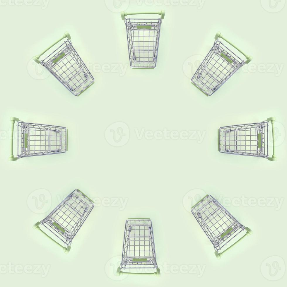 Pattern of many small shopping carts on a lime background photo