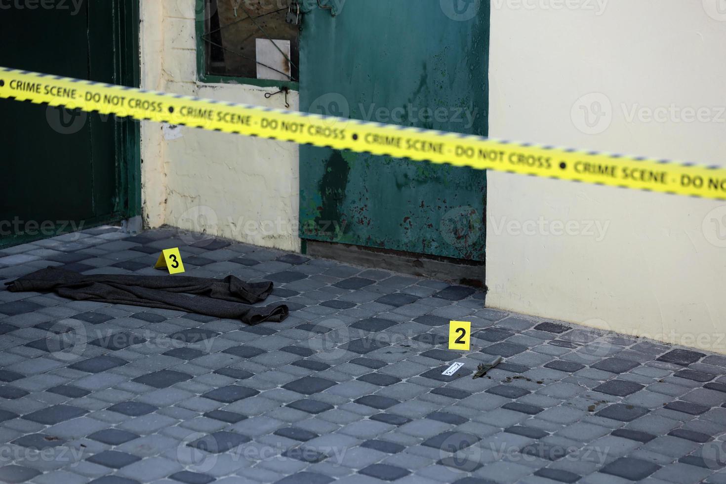 Crime scene tape for covering the area cordon. Yellow tape with blurred forensic law enforcement background in cinematic tone photo