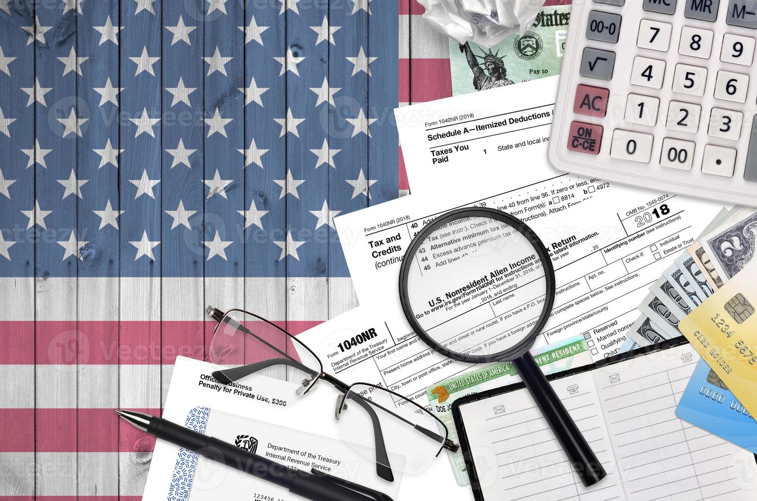 IRS form 1040NR Nonresident Alien Income tax return lies on flat lay office table and ready to fill. U.S. Internal revenue services paperwork concept. Time to pay taxes in United States photo