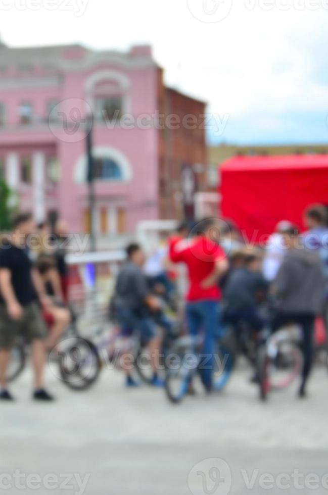 Defocused image of a lot of people with bmx bikes. Meeting of fans of extreme sports photo