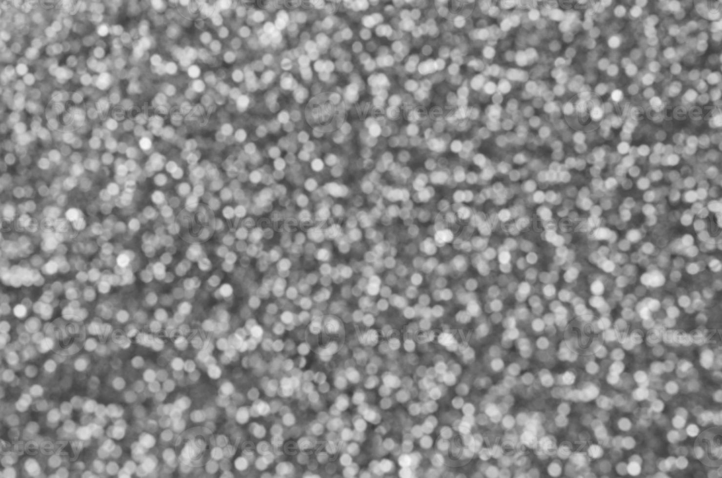 Blurred silver decorative sequins. Background image with shiny bokeh lights from small elements photo