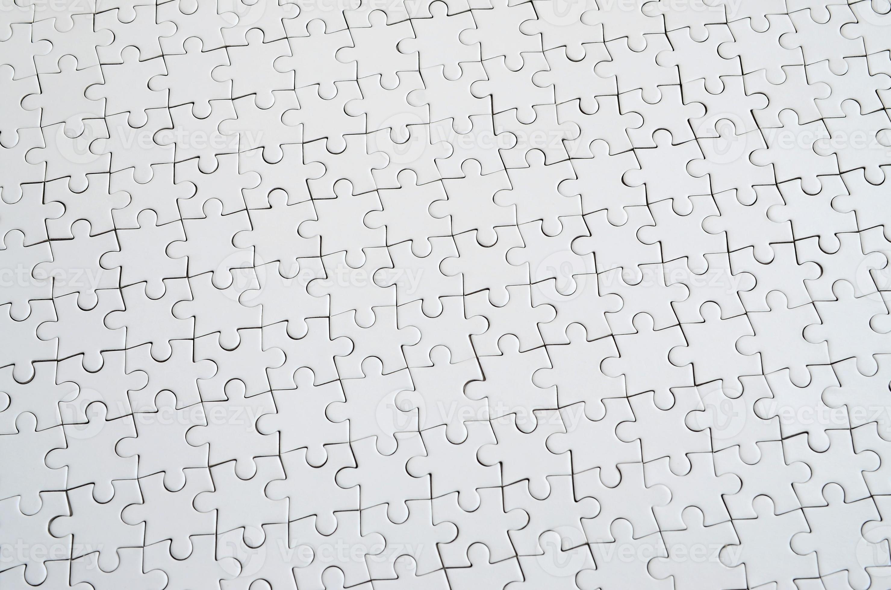 Close up texture of a white jigsaw puzzle in assembled condition. Top