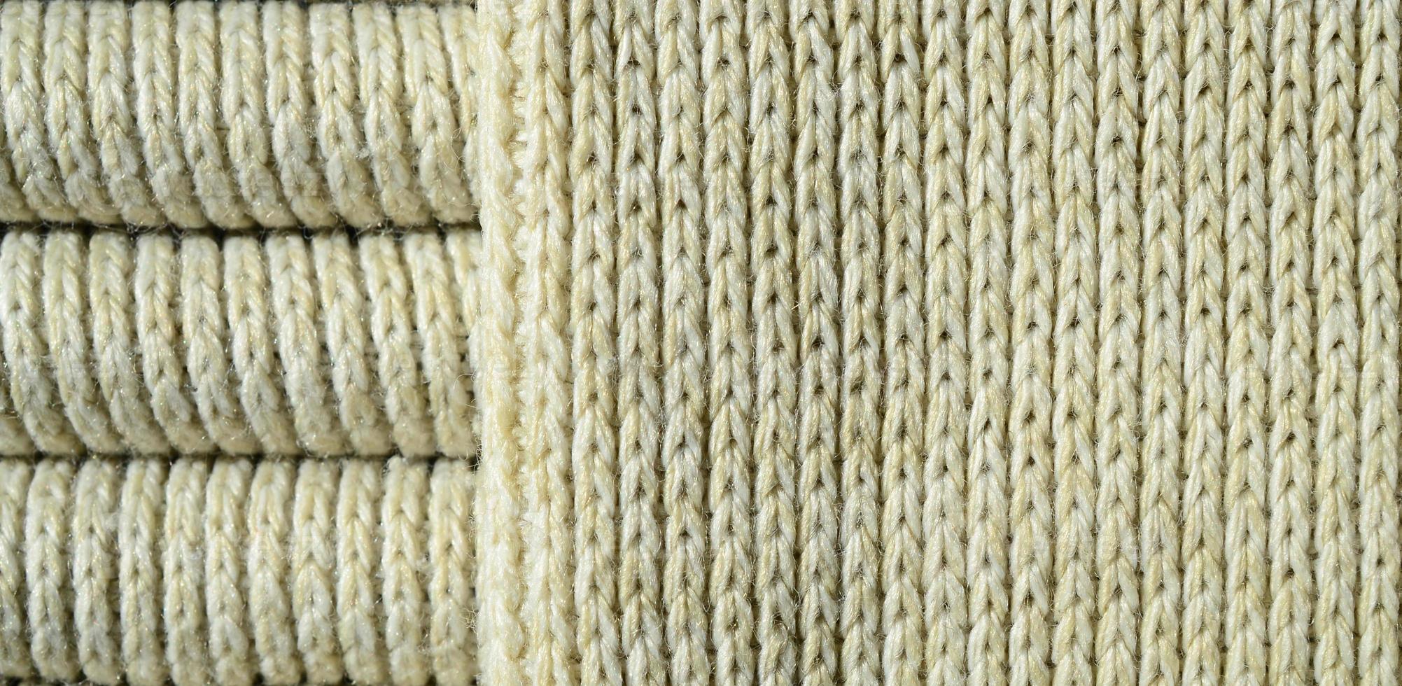 Composition of a soft yellow knitted sweater. Macro texture of bindings in yarns photo