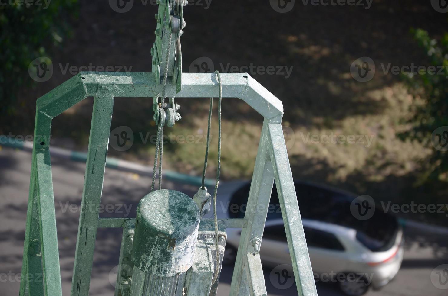 Hoist supply and safety lock as part of suspended wire rope platform for facade works on high multistorey buildings. Hoist for elevation, raising or lifting cradle photo