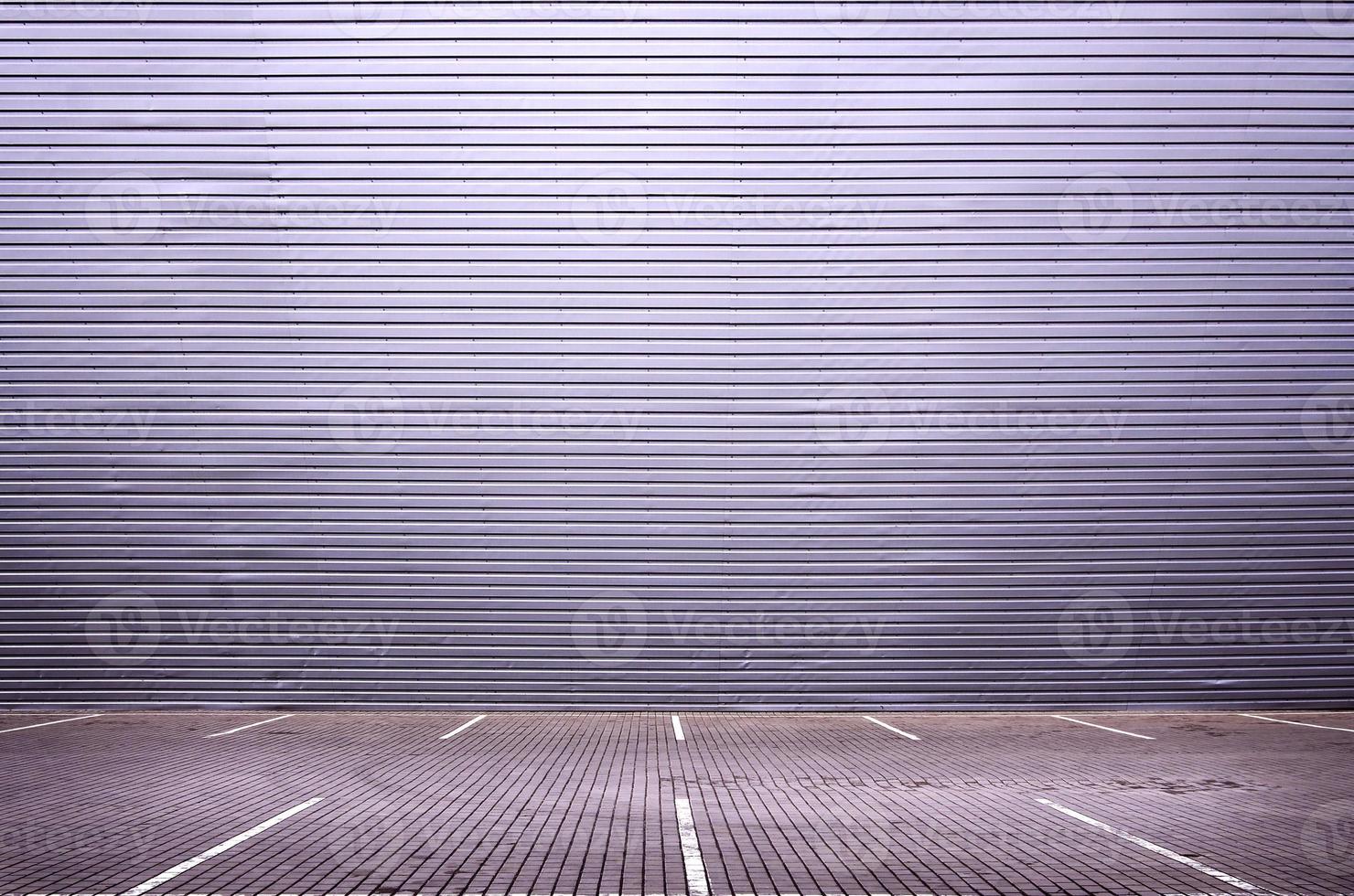 Empty parking spaces on the background of a metal wall with space for product placement photo