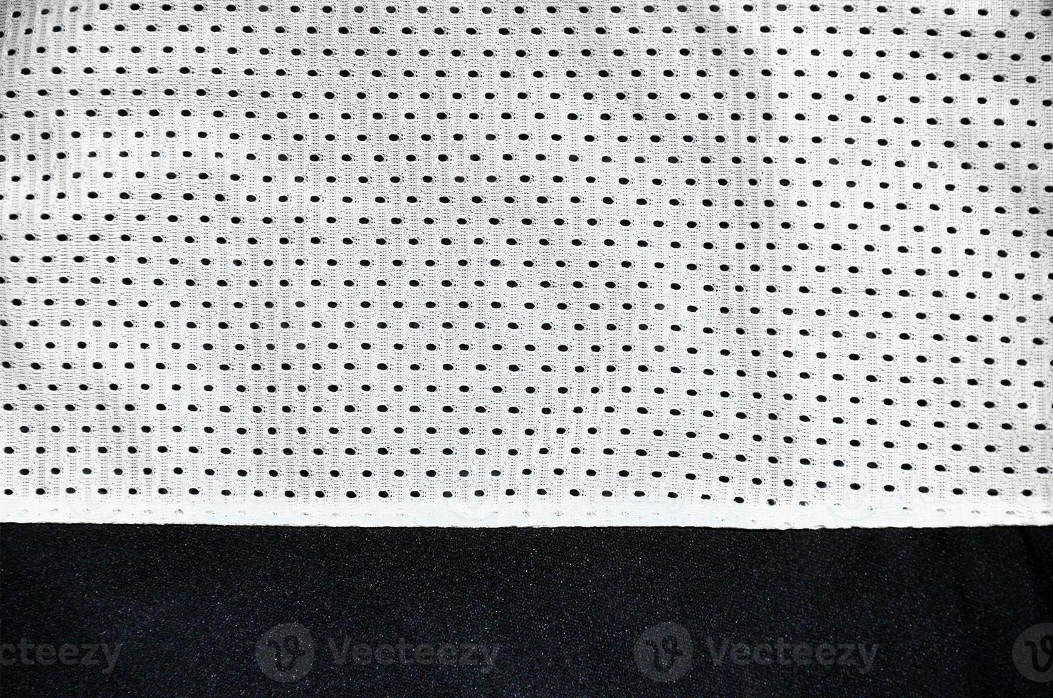 White sport clothing fabric texture background. Top view of white cloth textile surface. Bright basketball shirt. Text Space photo