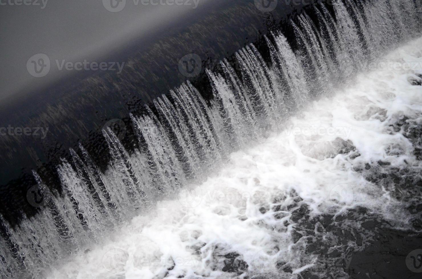 A picture of the flowing water. The dam is designed to regulate the water level in rivers within the city and to provide technical water to industrial objects photo