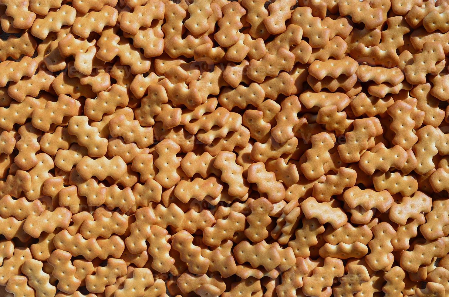 Pattern of a many yellow salted crackers photo
