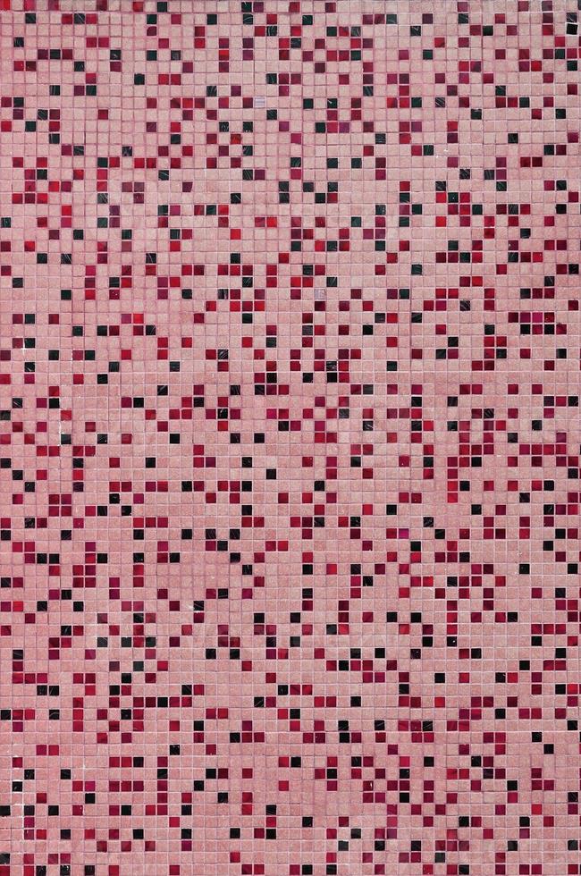 The texture of the wall, decorated with a mosaic of various small square tiles. Abstract pattern of ceramic tiles on the wall photo