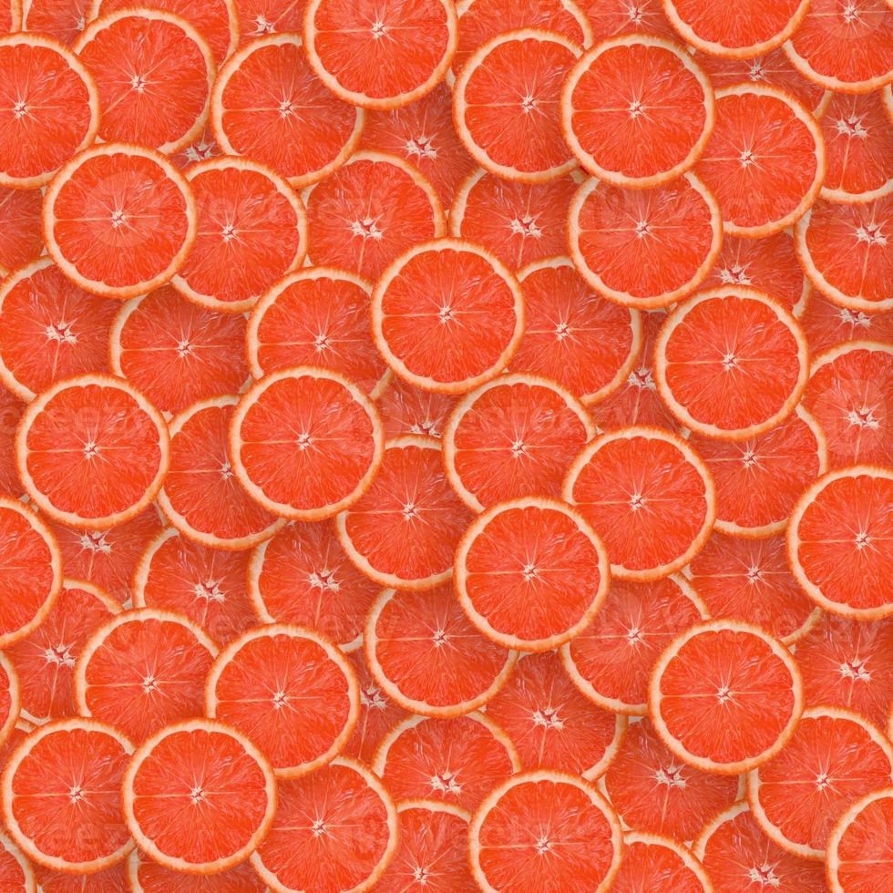 Pattern of red grapefruit citrus slices. Citrus flat lay photo