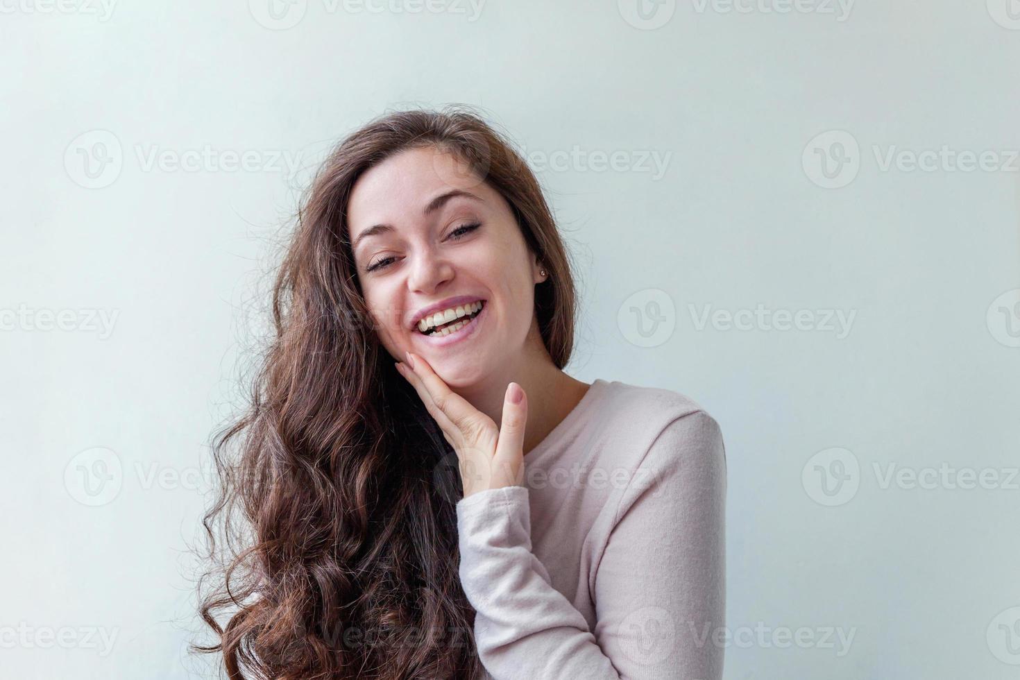 Happy girl smiling. Beauty portrait young happy positive laughing brunette woman on white background isolated. European woman. Positive human emotion facial expression body language. photo