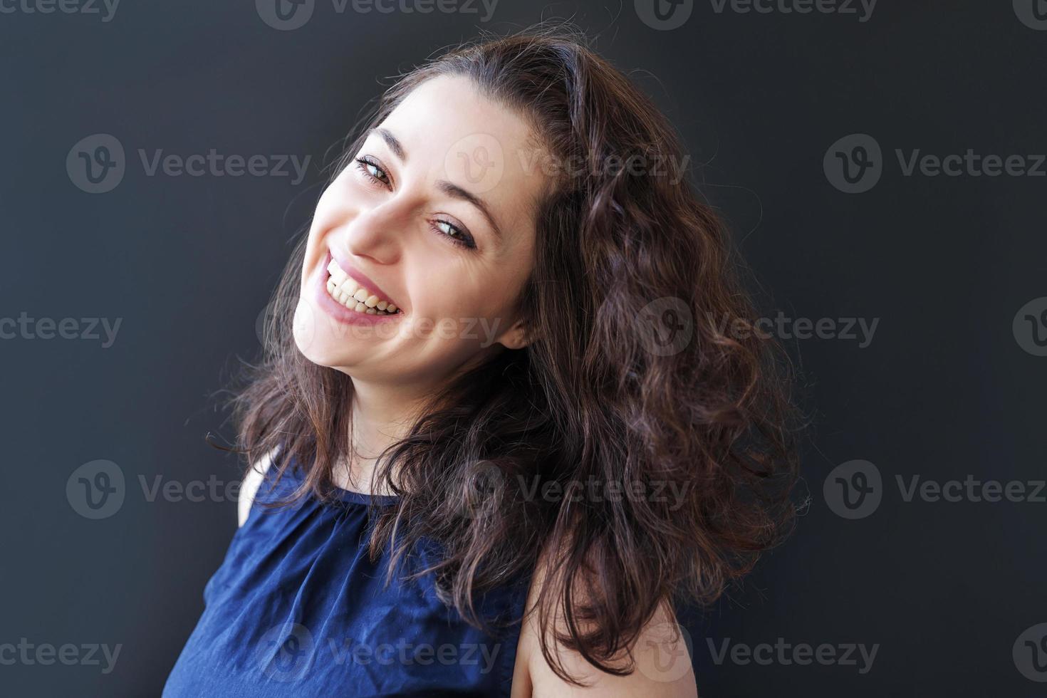 Happy girl smiling. Beauty portrait young happy positive laughing brunette woman on black background isolated. European woman. Positive human emotion facial expression body language photo