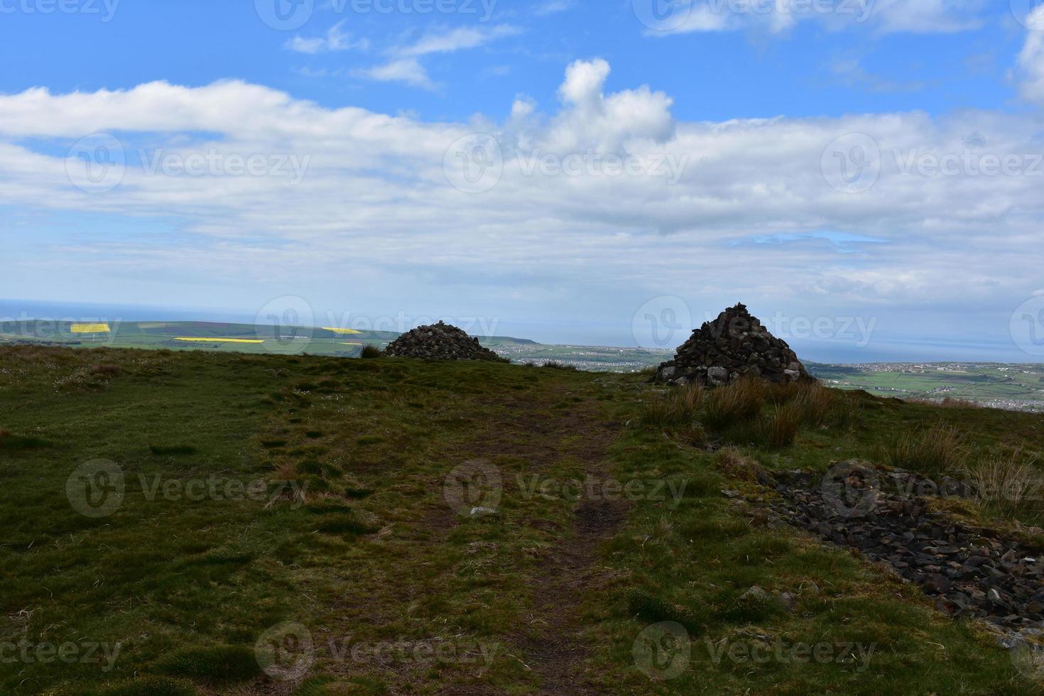 Dirt Pathway Leading to Twin Cairns Marking the Route photo