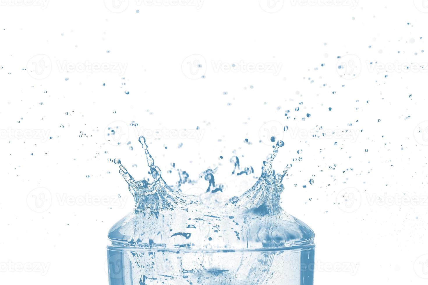 Top of transparent glass and blue water splash isolated on white background. photo