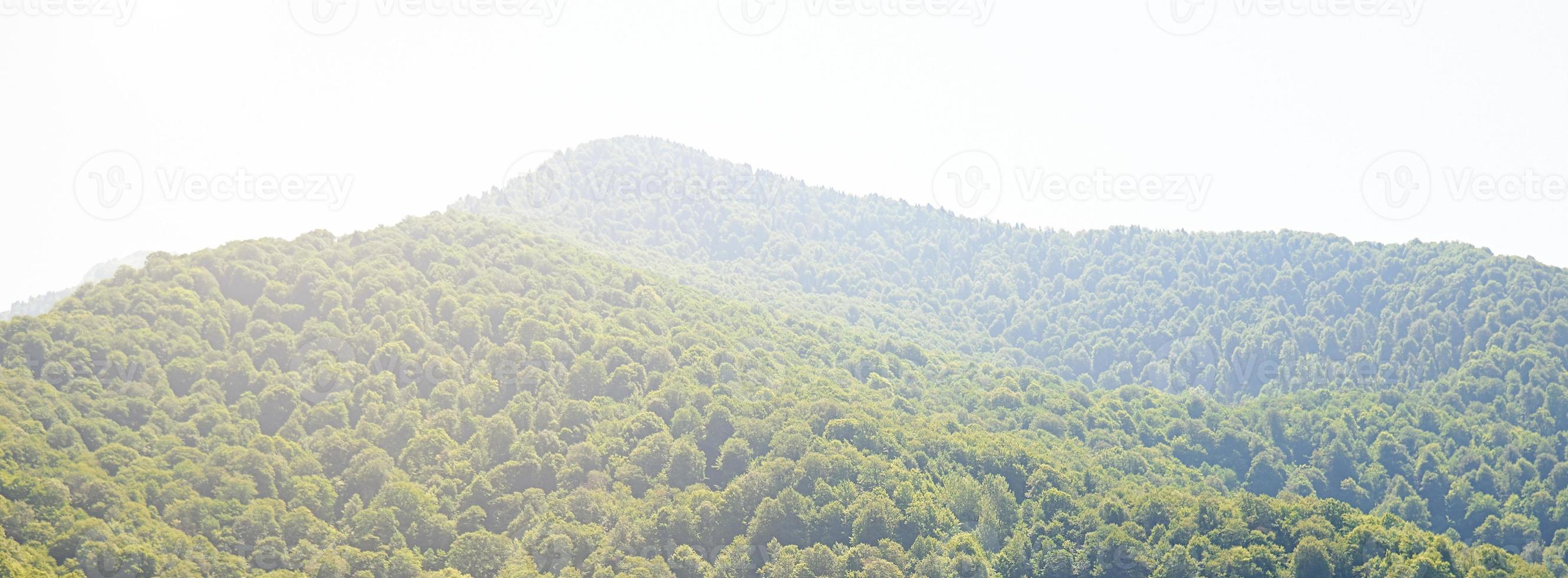 View of the green mountains illuminated by bright sunlight. photo