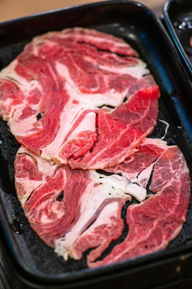 Slide raw beefs for Yakiniku. Thin piece beef for Shabu hotpot japanese food style. Close up fresh meat chuck eye for Sukiyaki. top view photo